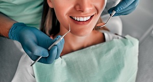 woman in dentist chair getting teeth examined